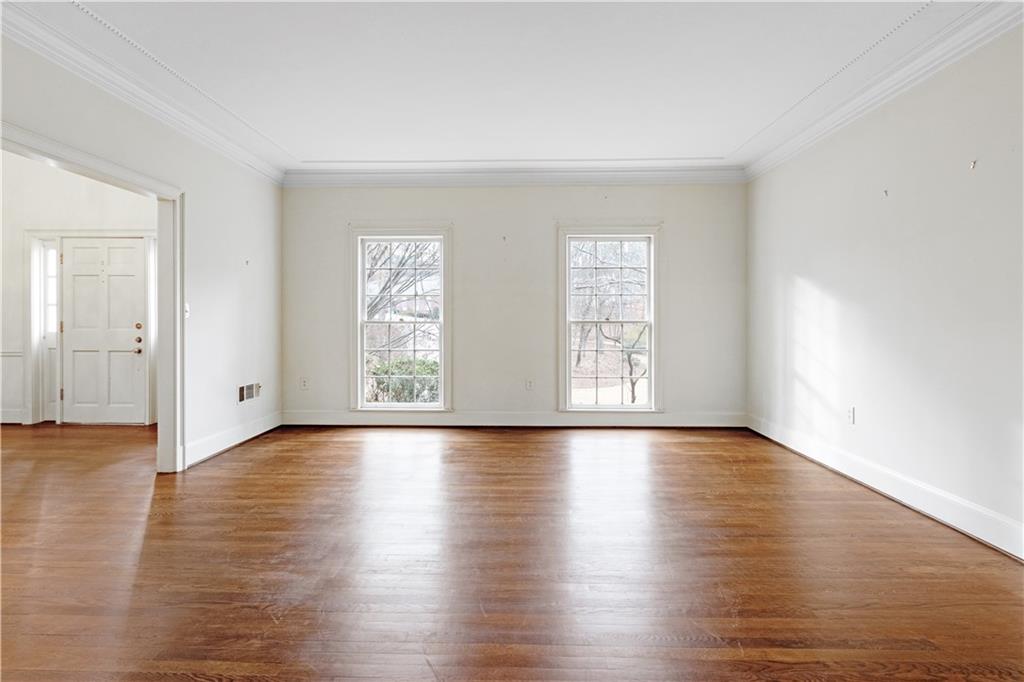 Living room with hardwood floors and crown molding