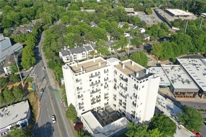 Multi-story building featuring numerous balconies and a flat roofline