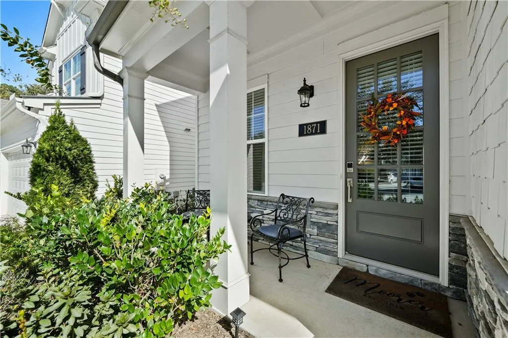 Entrance to property featuring a porch and a garage