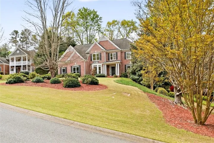 Brick exterior with covered entry. Beautiful mature landscaping on large lot.