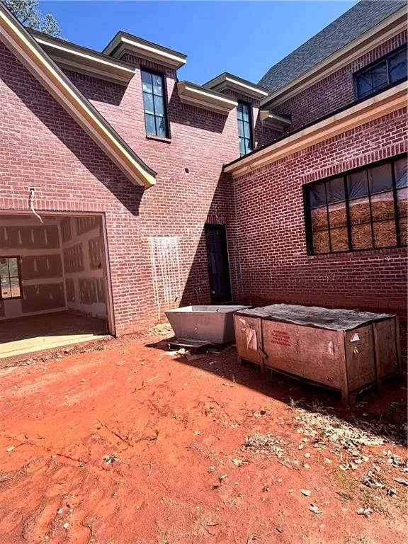 View of property exterior featuring brick siding