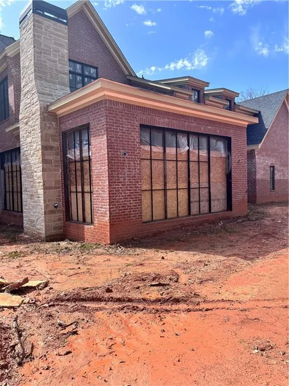 Rear view of house featuring brick siding