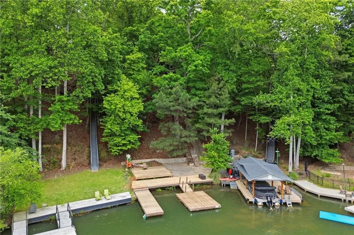Waterfront property featuring extensive dockage, a covered boat slip, and a permanent boat lift