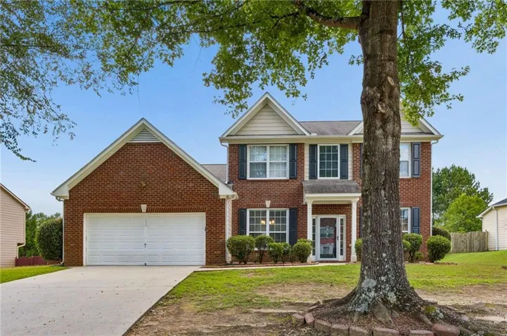 Two-story brick exterior with gabled roof lines and white trim