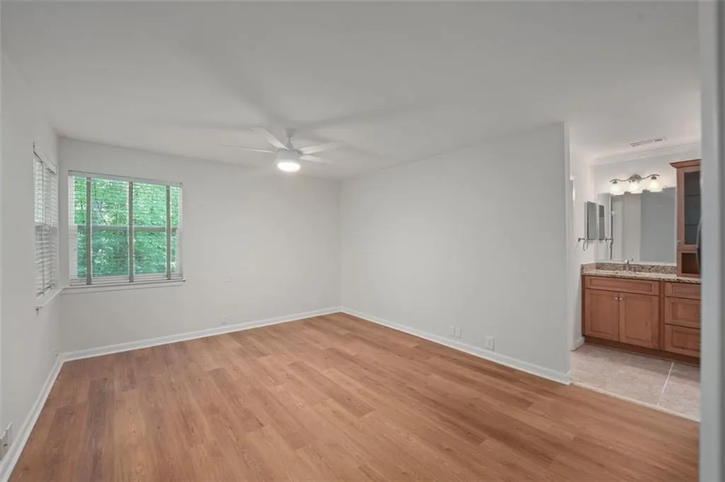 Large primary suite with new flooring, paint, fixtures, and smooth ceilings!