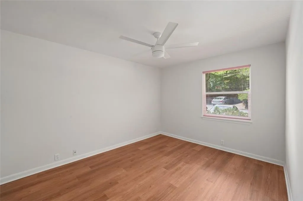 Second bedroom with new flooring, paint, and smooth ceilings!
