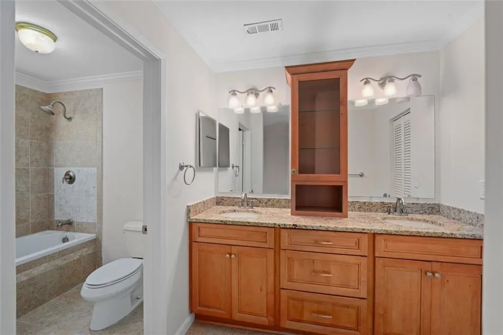 Renovated Primary Bath with double vanity, soft closed drawers, new fixtures and granite countertop