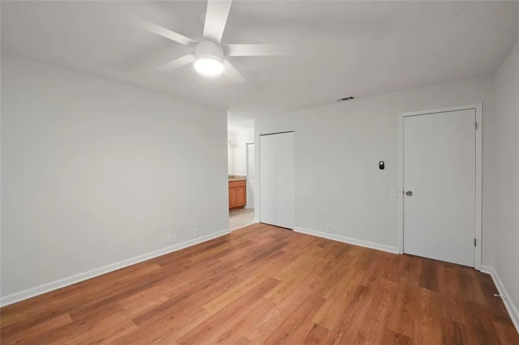 Primary Bedroom Suite with new flooring, painting, and smoothed ceilings and two closets