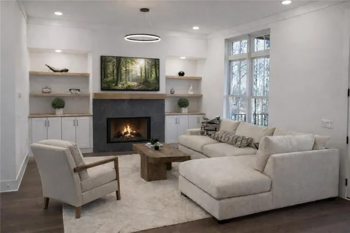 Main level great room with custom built-ins, open to main level balcony overlooking
