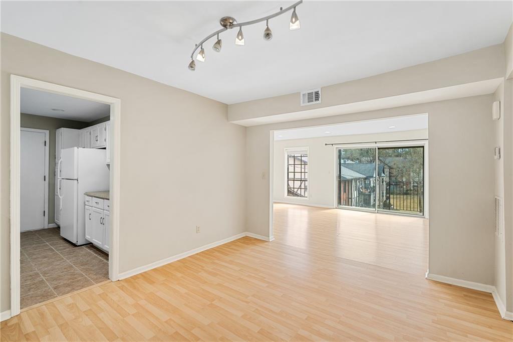 Spare room featuring light tile floors and rail lighting