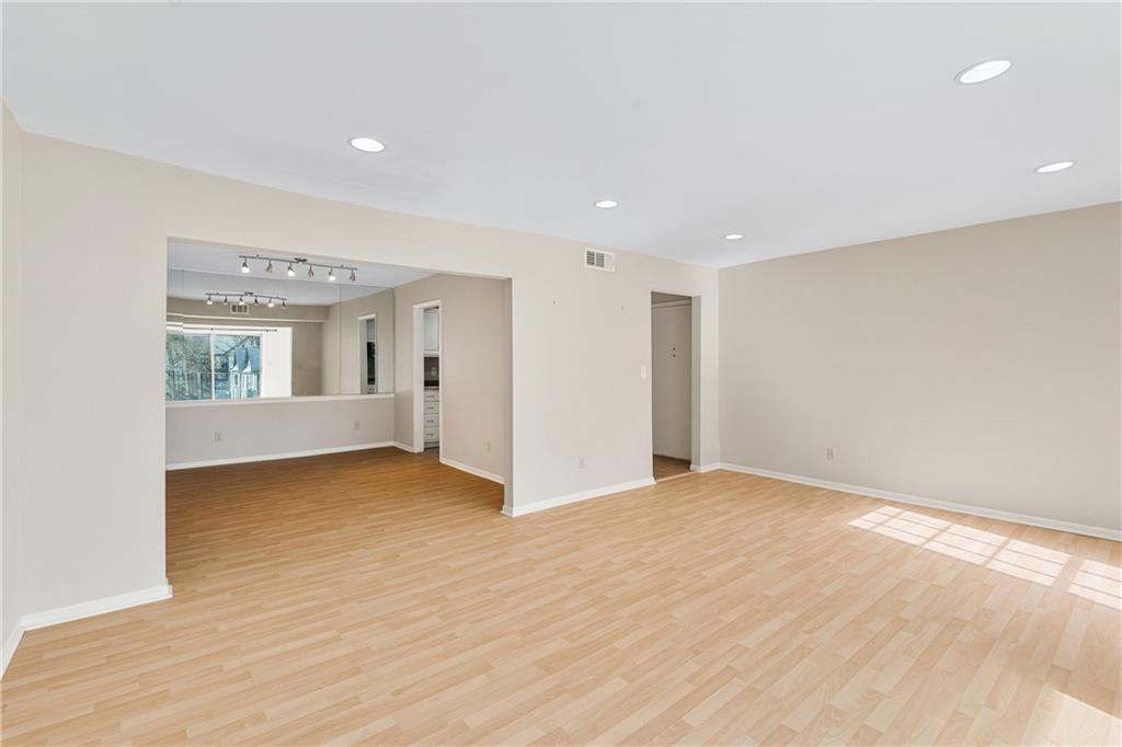 Unfurnished room featuring light hardwood / wood-style flooring and track lighting