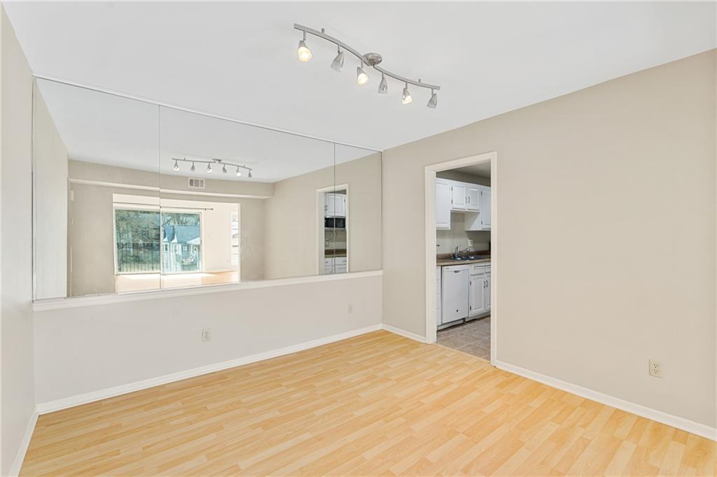 Unfurnished room featuring light wood-type flooring and track lighting