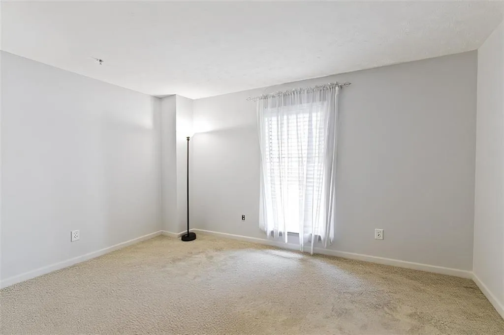 Unfurnished room with carpet floors and baseboards