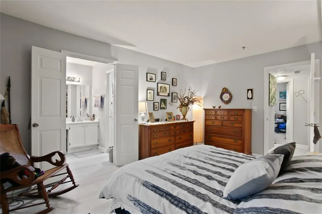 Bedroom featuring light wood-style flooring and ensuite bathroom