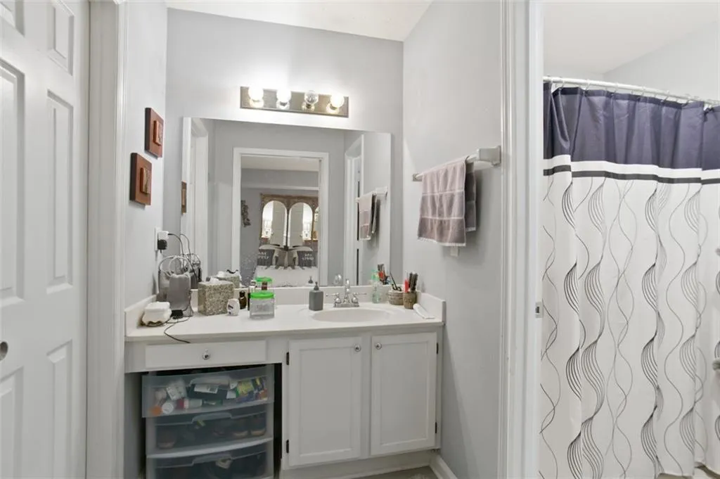 Full bath featuring vanity and a shower with shower curtain