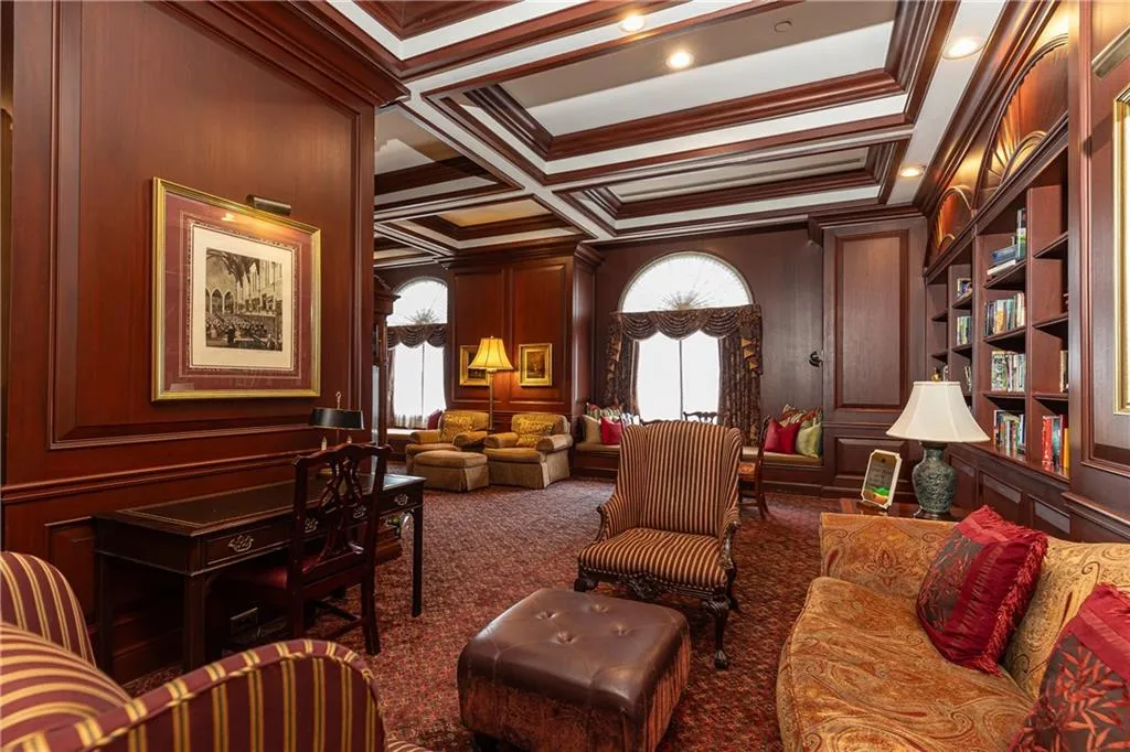 Common area with crown molding, a decorative wall, beam ceiling, and coffered ceiling