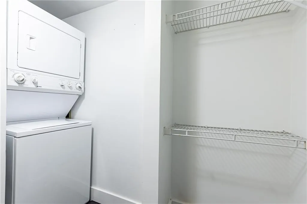 Laundry area featuring stacked washer / dryer