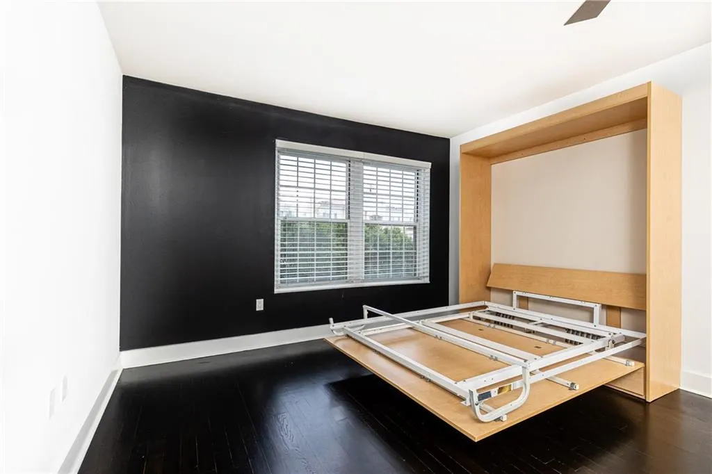 Bedroom with dark wood finished floors