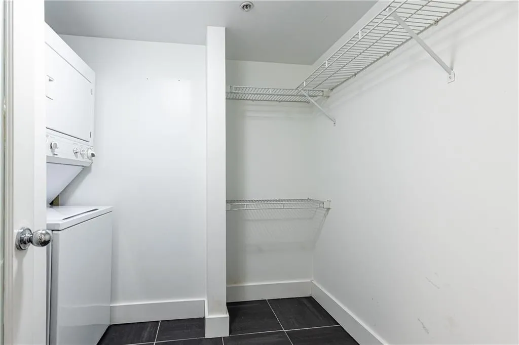 Walk in closet with dark tile patterned flooring