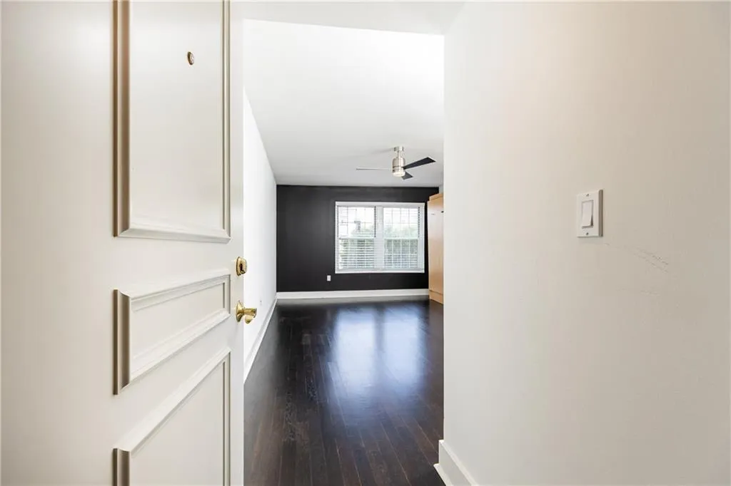 Corridor with baseboards and dark wood-type flooring