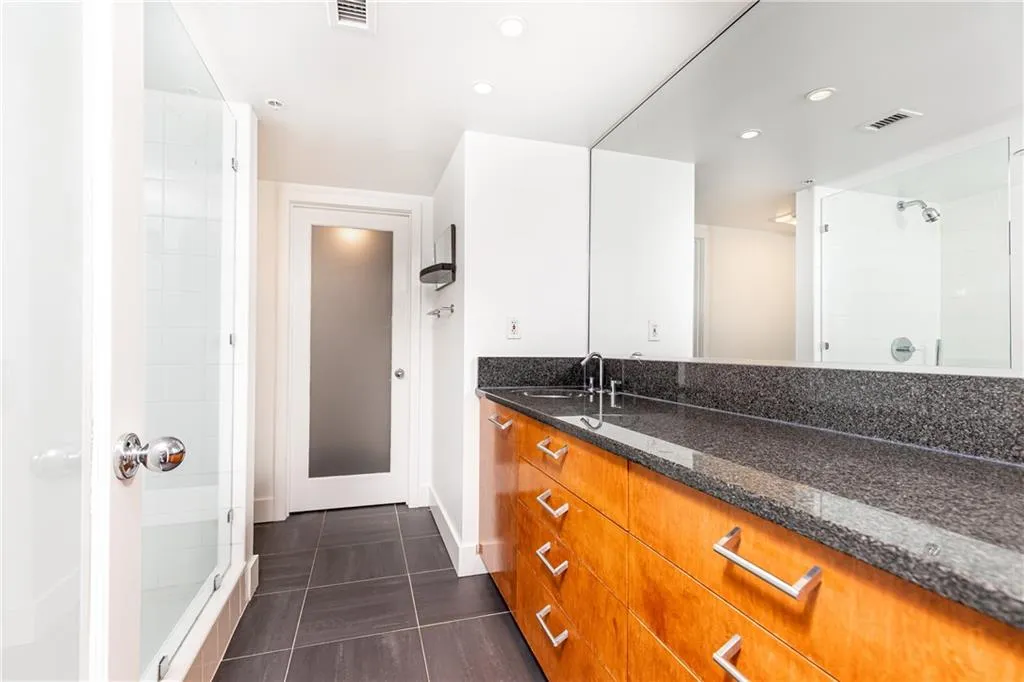 Bathroom with vanity, tile patterned floors, a stall shower, and recessed lighting