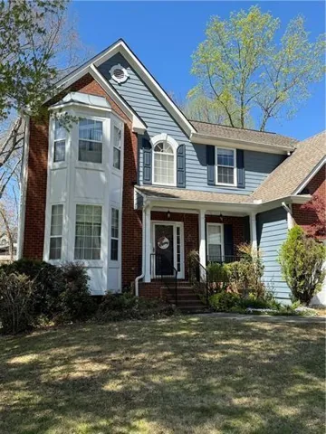 Front of property featuring a porch and a front lawn