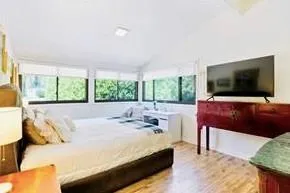 Primary Bedroom featuring multiple windows and Vaulted Ceilings