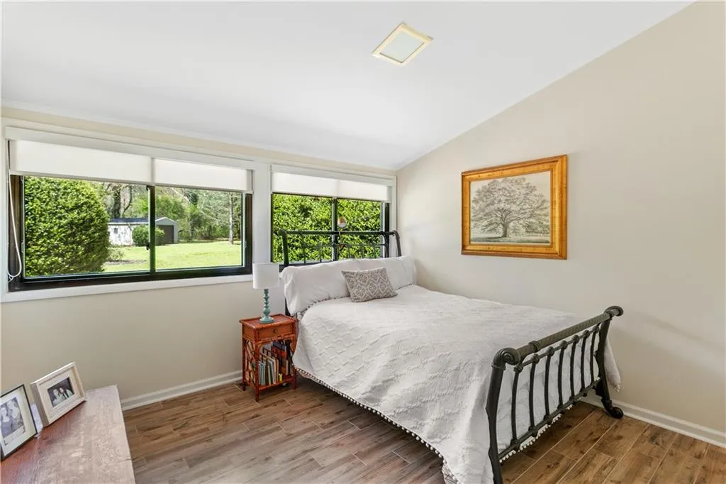Bedroom featuring vaulted ceiling and light hardwood / wood-style floors