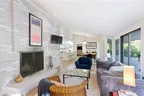 Living room featuring glass doors to patio and a large fireplace