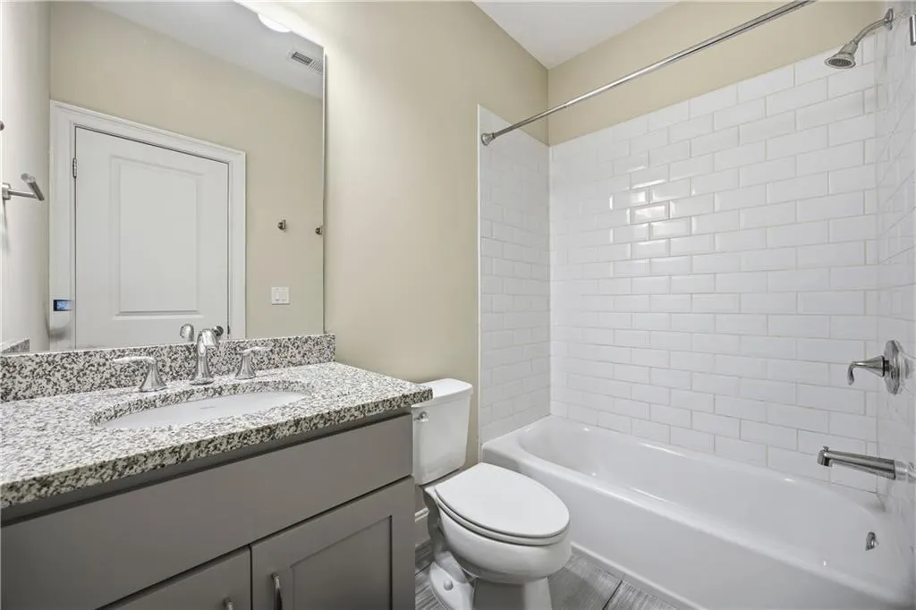 Bathroom featuring vanity and shower / washtub combination
