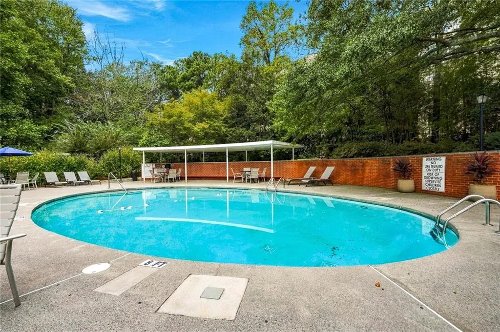 Oval swimming pool with concrete surround