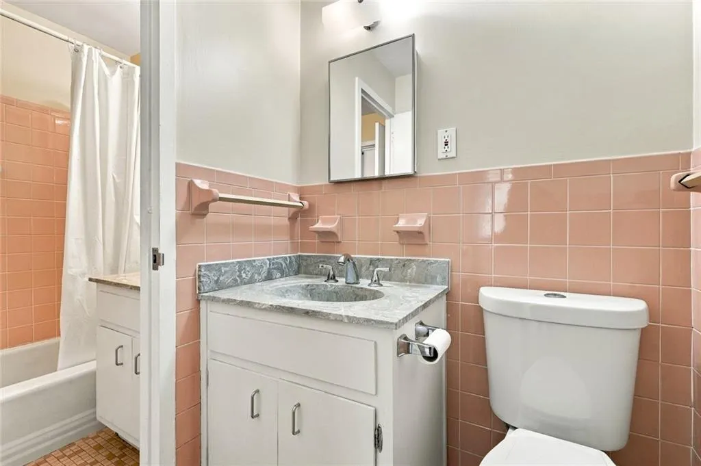 Vanity with stone countertop, integrated sink, and chrome faucet