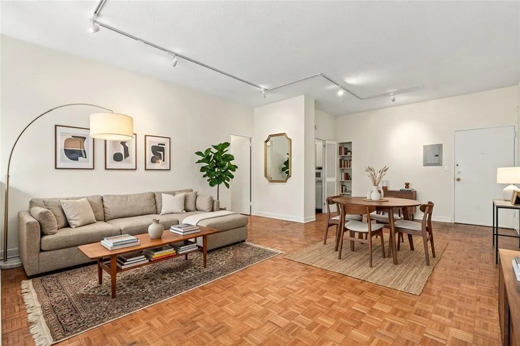 Parquet wood-finish flooring, track lighting, and a built-in shelving unit