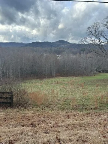 Expansive natural landscape featuring rolling hills and distant mountains