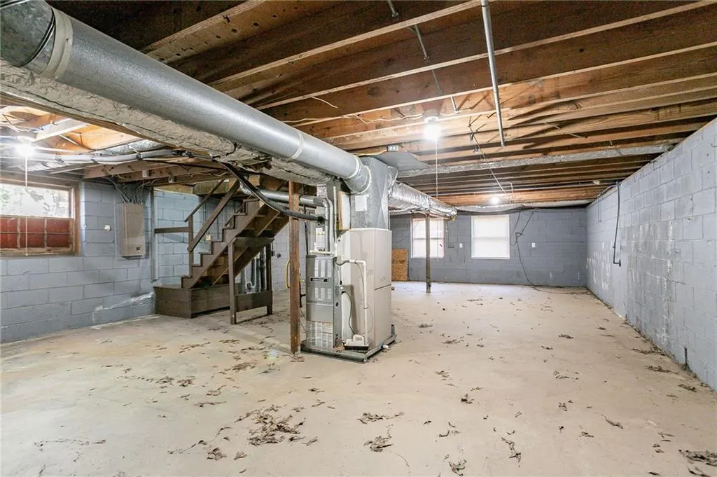 Basement with heating unit and stairs