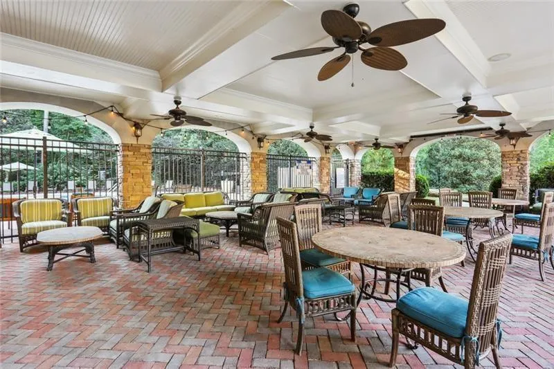 View of patio featuring ceiling fan, fence, and outdoor lounge area
