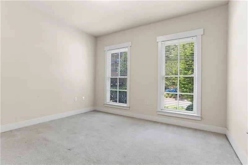 Carpeted empty room featuring baseboards