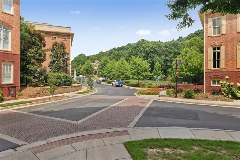 View of asphalt street featuring sidewalks and curbs