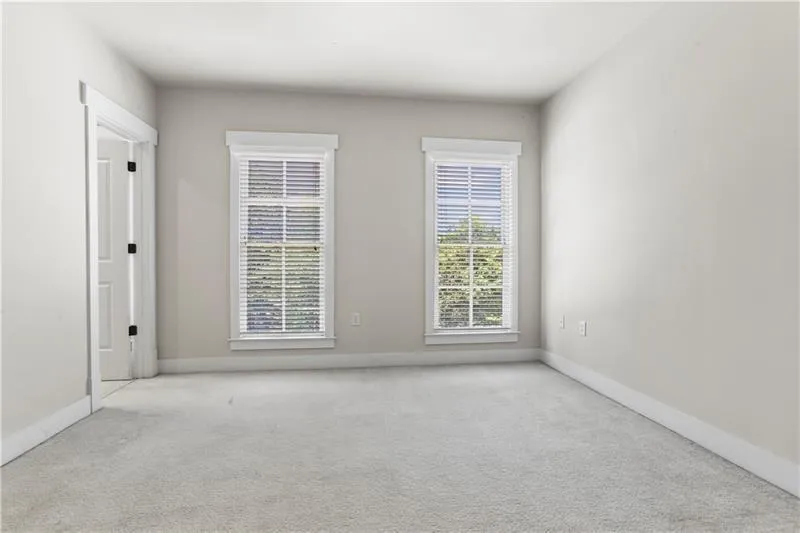 Unfurnished room with carpet and baseboards