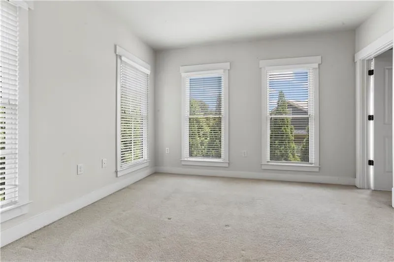 Empty room featuring carpet floors and baseboards