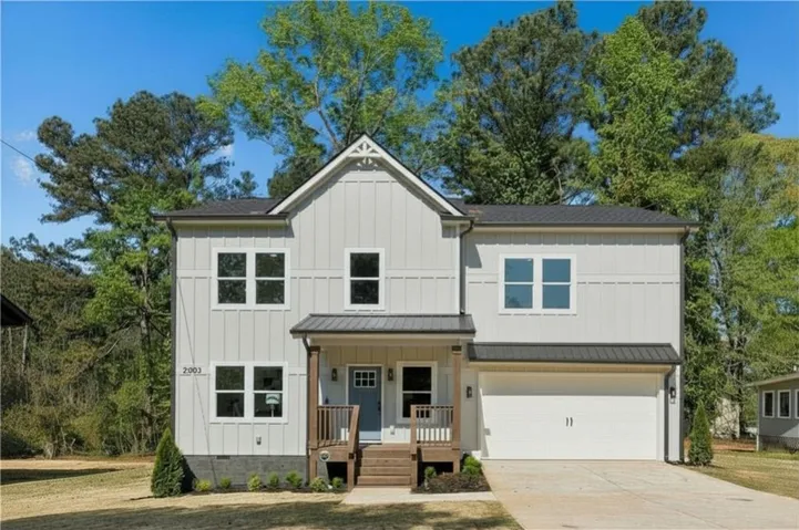 Light gray vertical siding exterior with contrasting dark roof