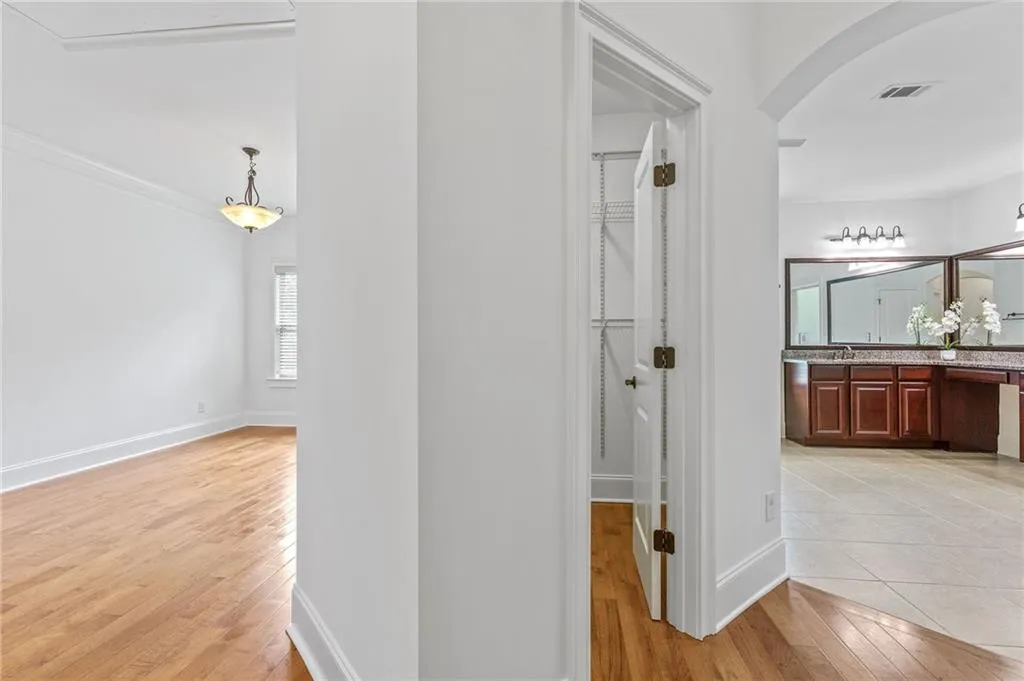 Primary Hallway featuring light hardwood / wood-style flooring and sink