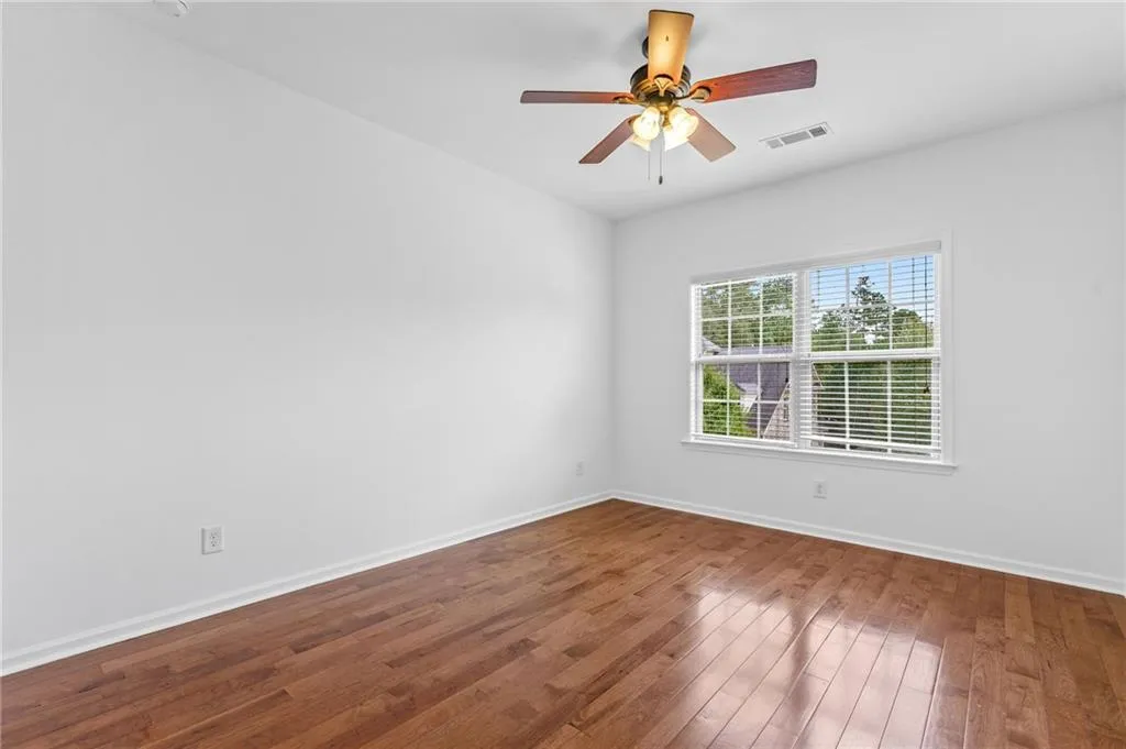 Upper Bedroom 2 with wood-type flooring and ceiling fan