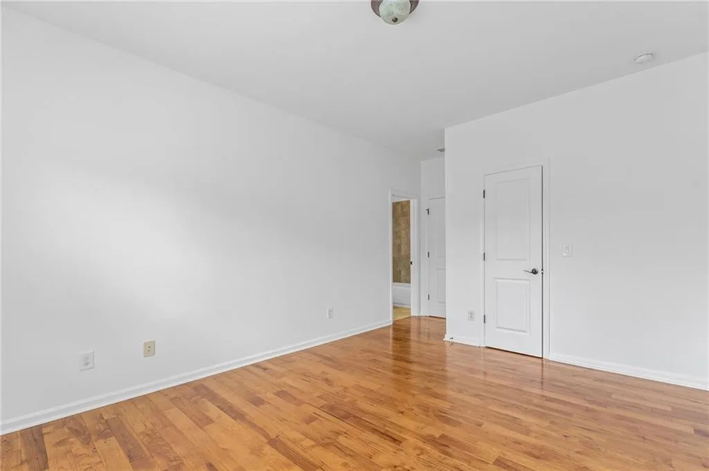 Upper bedroom 3 with attached full bath featuring light hardwood / wood-style flooring