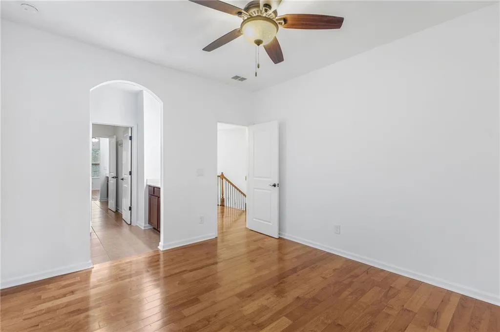 Upper Bedroom 1 featuring light hardwood / wood-style flooring and ceiling fan
