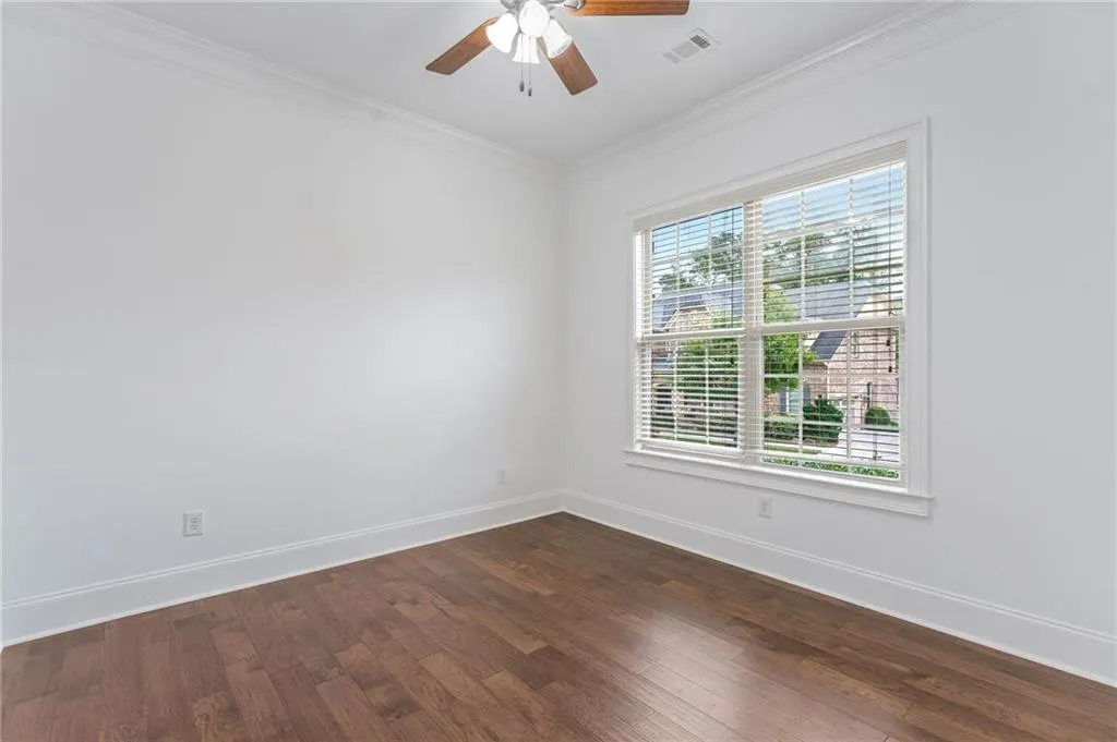Office featuring ornamental molding, hardwood / wood-style floors, and ceiling fan