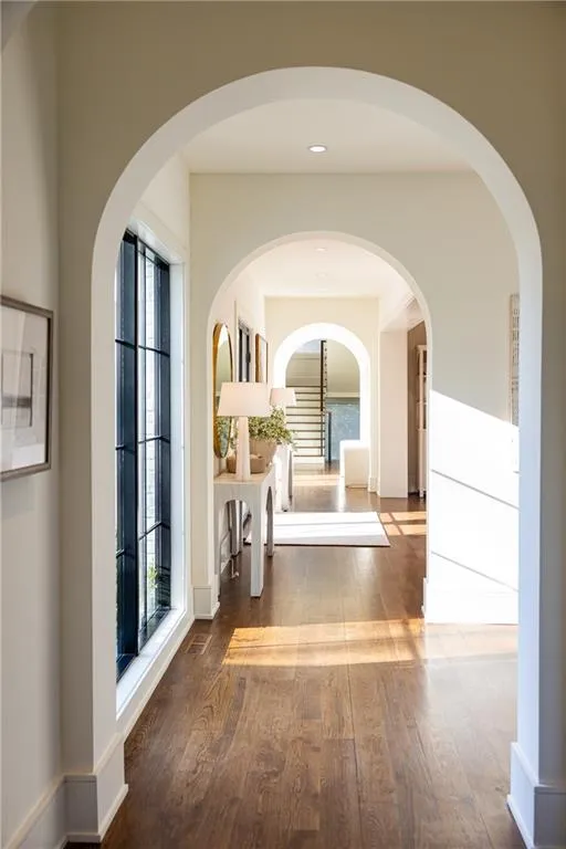 Arched Hallway past front door to stairway