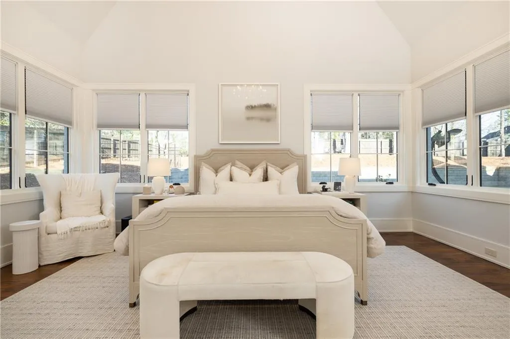 Primary Suite lined with windows overlooking yard and pool