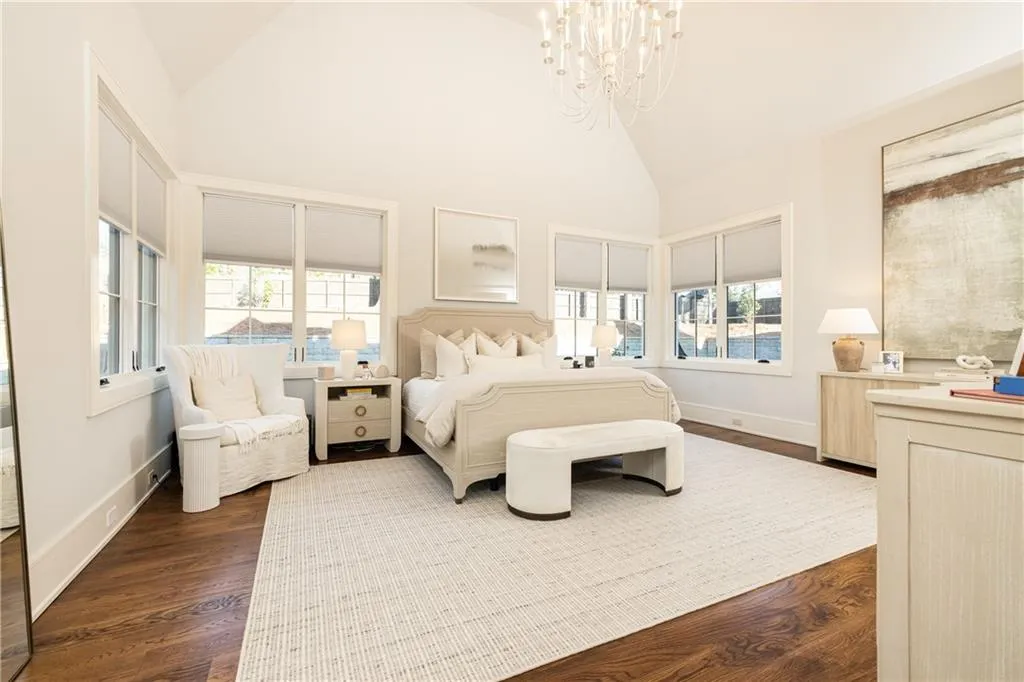 Primary Suite lined with windows overlooking yard and pool