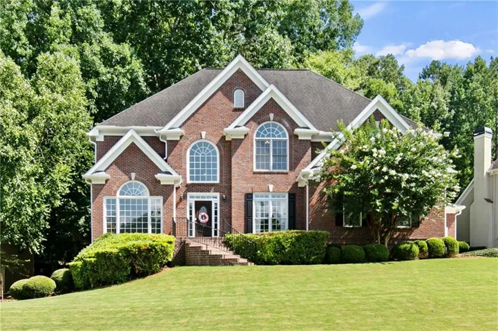 Traditional brick exterior featuring a gabled roofline and arched windows